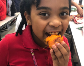 Kid biting sweet potato
